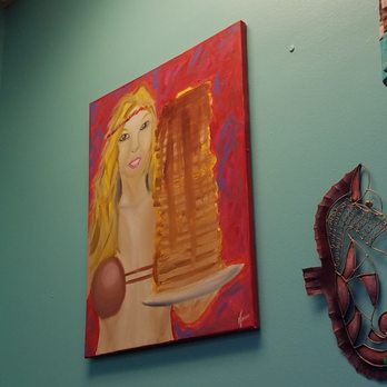 Friendly Toast Cafe 2 - The painting of one of their waitresses wearing a coconut bikini bra and carrying a stack of pancakes. - American Near Me - Melbourne, Florida