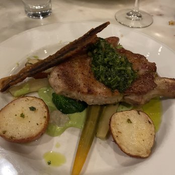 Otto's - Pork Ribeye 12 oz dry aged pork ribeye, green peas cream, chimichurri,red potatoes, veggie mélange - German Near Me - Fredericksburg, Texas