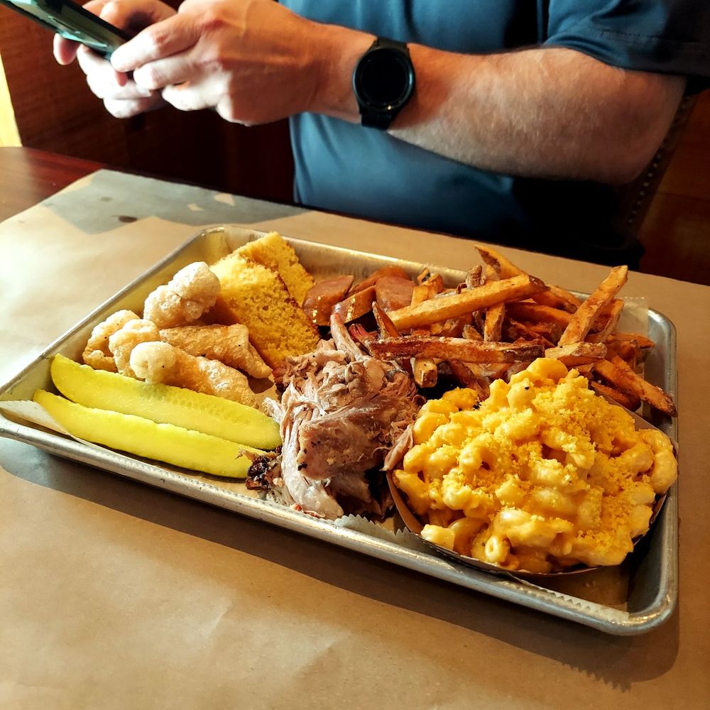 Pulled pork and sausage platter with fries, Mac and cheese, corn bread and pork rinds. Pulled pork and sausage platter with fries, Mac and cheese, corn bread and pork rinds.