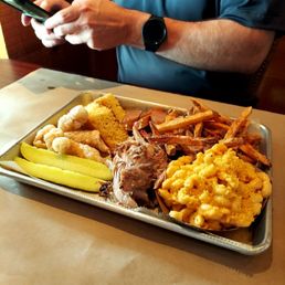Pulled pork and sausage platter with fries, Mac and cheese, corn bread and pork rinds.