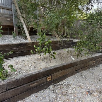 Brothers Landscaping - The large fence was in place. They worked around the fence and added a retaining wall in front of the fence and the two lower tiers. - Tree Services Near Me - Garland, Texas
