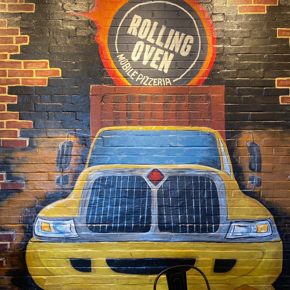 Rolling Oven - a yellow cab painted on a brick wall - Pizza Near Me - Versailles, Kentucky Rolling Oven - a yellow cab painted on a brick wall - Pizza Near Me - Versailles, Kentucky