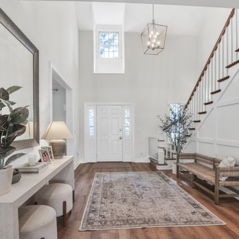 Bee Tree Homes - a foyer with a staircase and a foyer table - General Contractors Near Me - Jacksonville, Florida