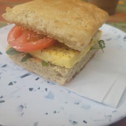 Anaya Coffee - BREAKWATER BREAKFAST SANDWICH: Egg frittata, tomato, greens, and cheese, between ciabatta bread.
