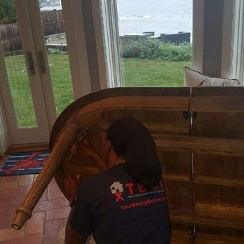 TEMS - A top mover dis-assembling dining room table in preparation for moving - Movers Near Me