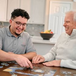 Griswold Home Care for North San Diego - Care aide and client work on a puzzle