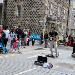 Assembly Gardens George Square - Street performance...he's playing guitar and improv-ing with lyrics.
