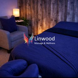 Linwood Massage & Wellness - Treatment room with Logo over imposed on the image.