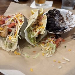 Fish tacos with black bean/ rice with sour cream. Fish tacos with black bean/ rice with sour cream.