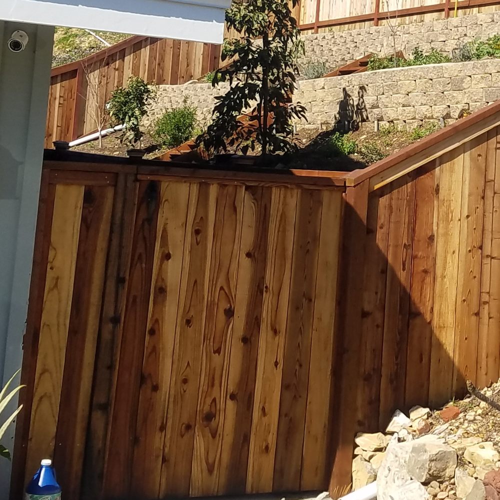 Smith Steven Construction - a wooden fence with a planter on top - General Contractors Near Me Smith Steven Construction - a wooden fence with a planter on top - General Contractors Near Me