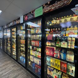Charter Way Gulf - Coolers stocked with an array of beer, seltzers, and beverages.