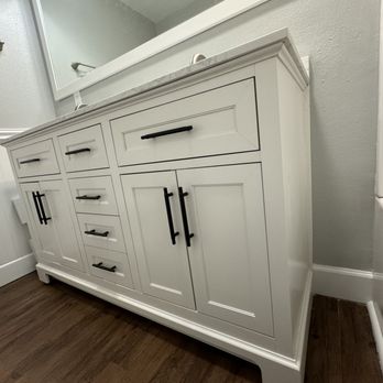 MD Painting General - a bathroom vanity with a mirror - Painters Near Me MD Painting General - a bathroom vanity with a mirror - Painters Near Me
