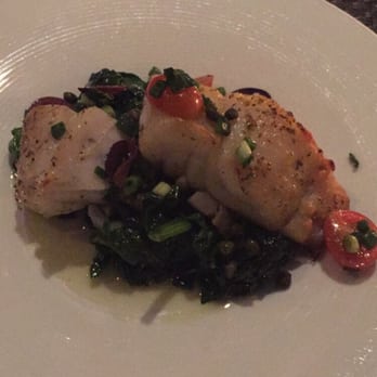 Nostos - Rockfish entree with grape tomatoes, olives, capers and scallions over spinach. Delicious! - Greek Near Me - Vienna, Virginia