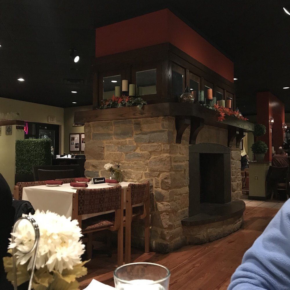 Oliva - The beautiful fireplace in the center of the restaurant. - Mediterranean Near Me - Madison, Wisconsin Oliva - The beautiful fireplace in the center of the restaurant. - Mediterranean Near Me - Madison, Wisconsin