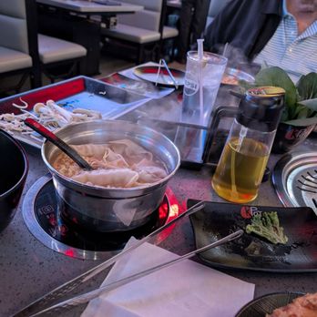 KPOT Korean BBQ & Hot Pot - Thai Tom Yum soup base with ramen, Gyoza, bamboo shoots, bean sprouts. - Barbeque Near Me - Shenandoah, Texas
