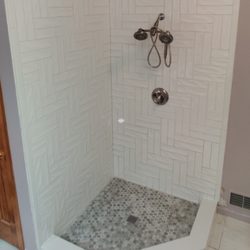Howland Home Services - Rebuilt failed shower using subway in a herringbone pattern.