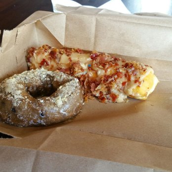 Hurts Donut - Blueberry and a maple frosting and bacon on a long glazed. - Donuts Near Me - Frisco, Texas Hurts Donut - Blueberry and a maple frosting and bacon on a long glazed. - Donuts Near Me - Frisco, Texas