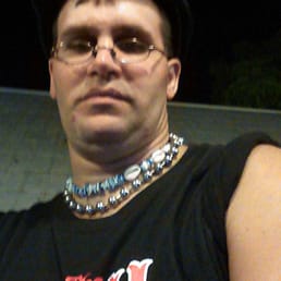 a man wearing a black shirt and a hat a man wearing a black shirt and a hat