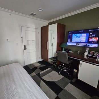 Le Meridien Indianapolis - Closet, desk, tv and mini fridge - Hotels Near Me - Indianapolis, Indiana