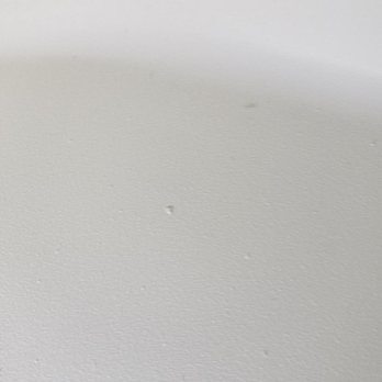 Ace Permaglaze - Chunky, rough surface of shower pan with chip in background - Countertop Installation Near Me - Tucson, Arizona