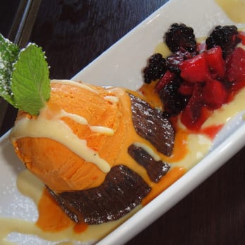 Piqueo's - Our dessert Molten Lava Cake served with fruit and ice cream. - Latin American Near Me - San Francisco, California Piqueo's - Our dessert Molten Lava Cake served with fruit and ice cream. - Latin American Near Me - San Francisco, California