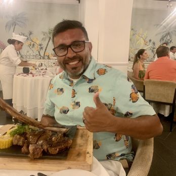 Excellence Riviera Cancún - My hubby enjoying his tomahawk steak - he said it was delicious but that it was very very fatty - Hotels Near Me - Puerto Morelos, ROO