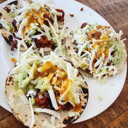 La Perla Tapatia Meat Market - Tacos campechanos (ranchera + chorizo) with diced cabbage and red onion, cheese, and red and green salsa.