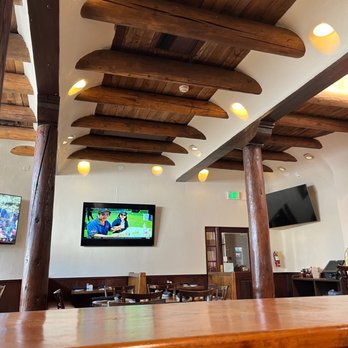 The Bourbon Grill - a bar with a television on the wall - Steakhouses Near Me - Santa Fe, New Mexico