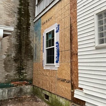 Gitr Done - a house with a boarded window - Handyman Near Me
