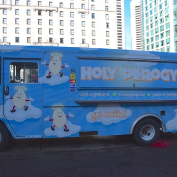 Holy Perogy - a blue food truck on a city street - Street Vendors Near Me