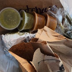 Taqueria El Tapatio - Peek inside the bag... 2 burritos, a burger, salsas, and condiments.