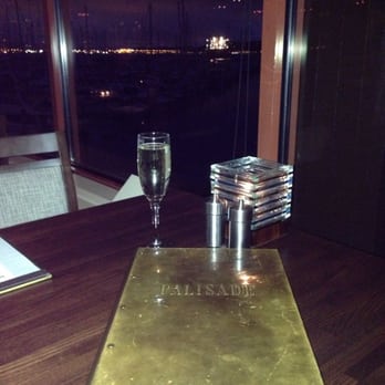 Palisade - Prosseco and menu in the dimly lit restaurant with a view - Seafood Near Me - Seattle, Washington Palisade - Prosseco and menu in the dimly lit restaurant with a view - Seafood Near Me - Seattle, Washington