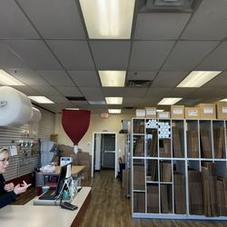 Pak Mail - A diligent knowledgeable employee near her packing supplies and her array of assorted size boxes for your convenience