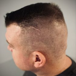 850 Cuts - High skin fade with a hard part on the right side.