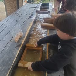 Child #2 sifting through the bag of gravel to find the precious gemstones