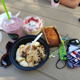a bowl of oatmeal, a loaf of banana bread, and a pair of sunglasses on a picnic table a bowl of oatmeal, a loaf of banana bread, and a pair of sunglasses on a picnic table