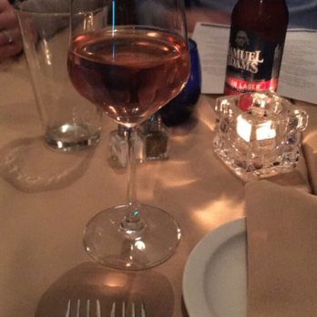 Amici Ristorante - Glass of wine and table setting - Italian Near Me - Kenmore, New York Amici Ristorante - Glass of wine and table setting - Italian Near Me - Kenmore, New York