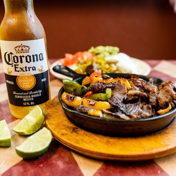 Los Gallos Taco House - a plate of food and a bottle of corona extra - Mexican Near Me - New Braunfels, Texas Los Gallos Taco House - a plate of food and a bottle of corona extra - Mexican Near Me - New Braunfels, Texas
