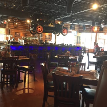 Ford's Garage Estero - The dining area and bar, sit at the bar while an antique Ford hangs over you - Bars Near Me - Estero, Florida