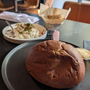 District Kitchen & Cocktails - Fresh Baked Bread with Whipped Feta and Pita in the background - New American Near Me - Austin, Texas