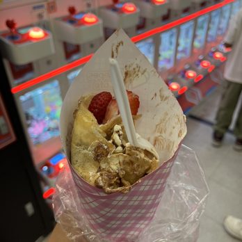 J Crepes & Cafe - a person holding a paper cone with a strawberries on it - Desserts Near Me - San Diego, California