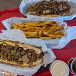 Two Philly sandwiches and a fries