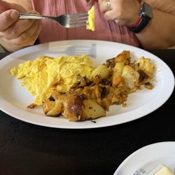 My wife's scrambled eggs with home fries and toast.