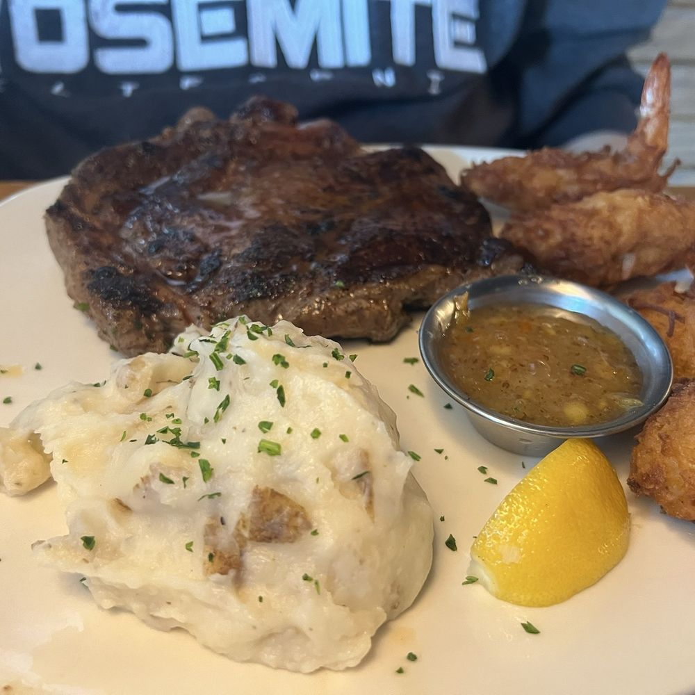 Ribeye* 13 oz. + Gold Coast Coconut Shrimp** + Loaded Mashed Potatoes Ribeye* 13 oz. + Gold Coast Coconut Shrimp** + Loaded Mashed Potatoes