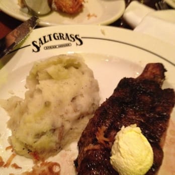 Saltgrass Steak House - Half of the cowboy rib eye, garlic mashed potatoes and add-on coconut shrimp. - Steakhouses Near Me - Laughlin, Nevada