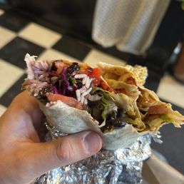 Vegan burrito with salsa verde and homemade hot sauce