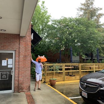 Eliza Restaurant & Bar - The hubs using our kids' umbrella to show off the patio on this rainy day. - Cocktail Bars Near Me - Baton Rouge, Louisiana Eliza Restaurant & Bar - The hubs using our kids' umbrella to show off the patio on this rainy day. - Cocktail Bars Near Me - Baton Rouge, Louisiana