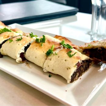 Tanoor - Fatayir Spaneekh: baked Lebanese pie stuffed with spinach, onions, sumac, & pomegranate molasses. Portion is enough for a meal  $13.  5* - Lebanese Near Me - Sammamish, Washington