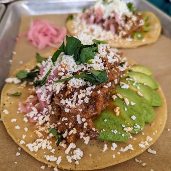 Franklin Motors - Pineapple Chipotle Tacos. $18. Braised pulled pork, pineapple sauce, chipotle, coriander, ginger, orange, avocado, pickled onion, cilantro+. - Beer Gardens Near Me - Chapel Hill, North Carolina
