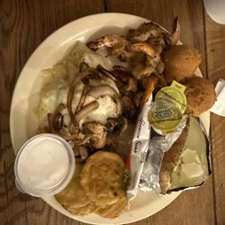 Tala Bay Seafood & Grill - Stuffed flounder and grilled shrimp with baked potato and fried sausage.